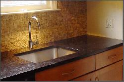 Dark Granite Kitchen Countertops and Stainless-Steel Sink