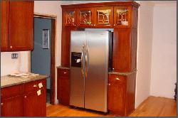 Kitchen Pantry Cabinets Around Stainless-Steel Refrigerator
